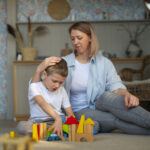 mother-playing-with-her-autistic-son-using-toys